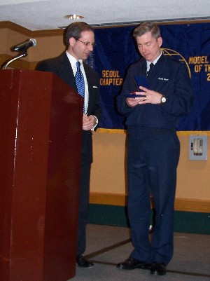Nathan Colodney, chapter president (l), presents Lt. Gen. Charles Croom, USAF, with an AFCEA crystal paperweight to thank him for speaking at the chapter's technical forum luncheon in March.